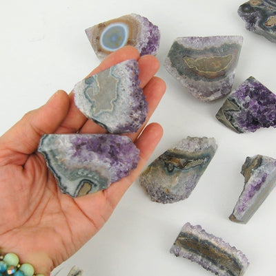 Amethyst Stalactite Paper Weights in hand for size reference