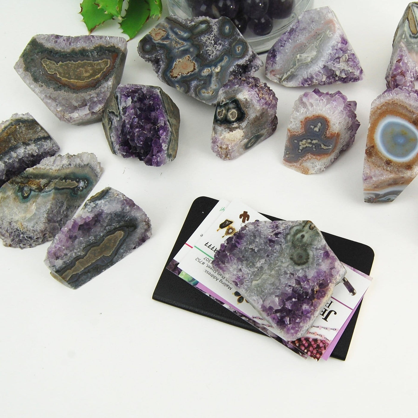 multiple Amethyst Stalactite Paper Weights displayed to show they can be used to hold down business cards