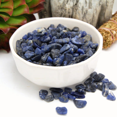 tumbled sodalite small stones in bowl with some laid out to show size 