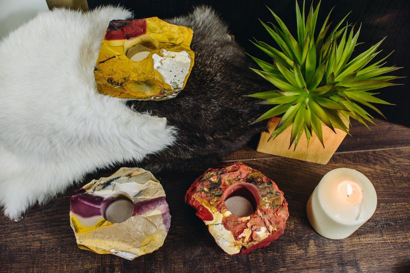 3 mookaite candle holders on a wood background