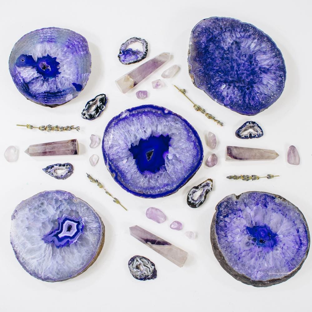 Picture of Five of our purple thick coasters, decorated by purple towers and amethyst tumbled stones. 
