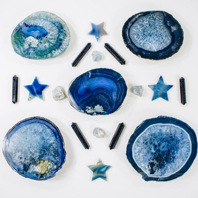 This Picture is showing four of our blue thick style coasters we have available, with some decorative stars and agate double terminated points aswell.