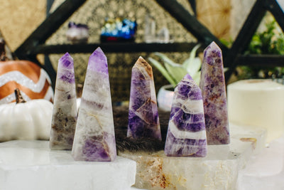 Chevron amethyst towers are being displayed next to each other, on a nice and cozy looking back ground.