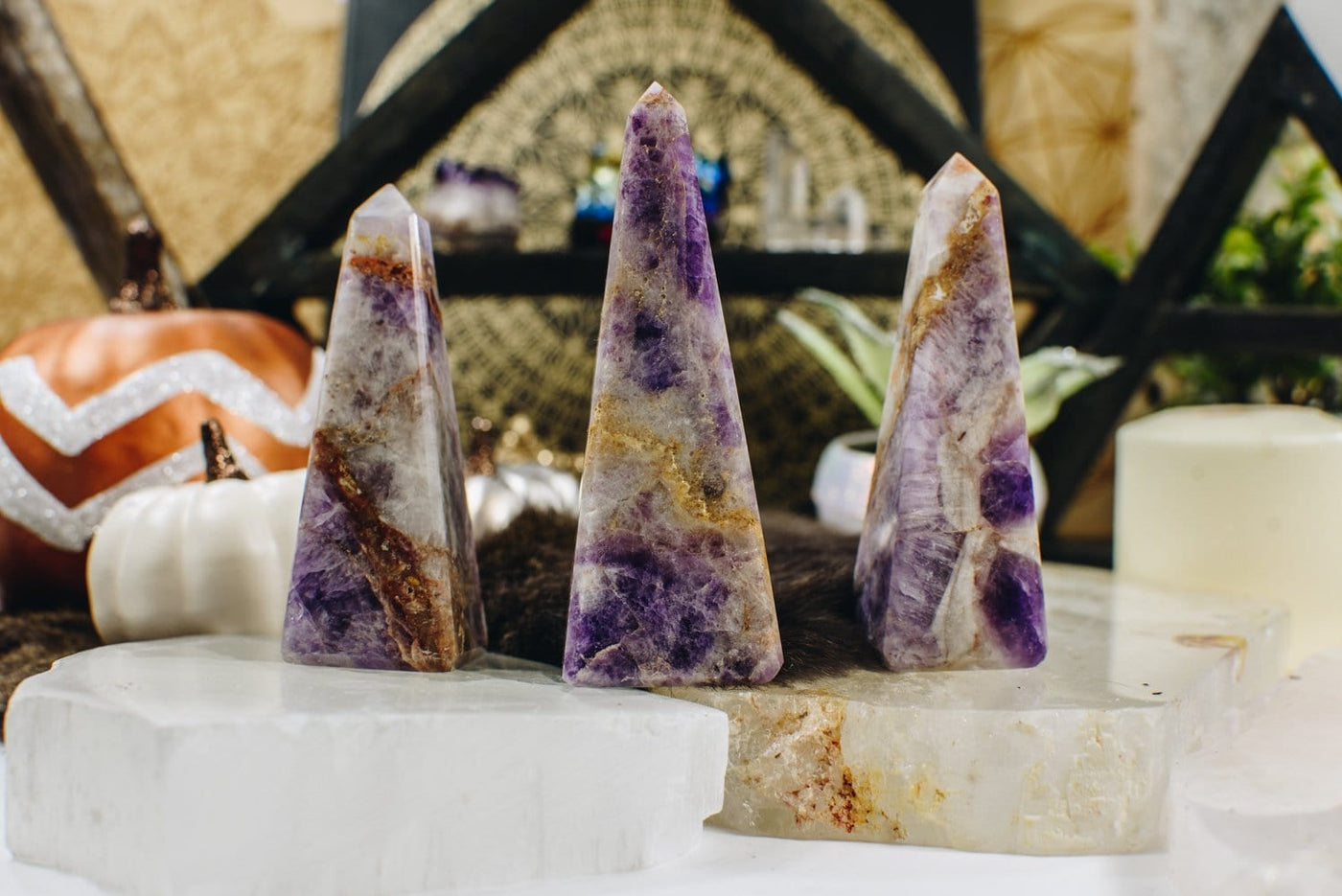 Obelisks Points are being displayed on a selenite and crystal quartz platter. 