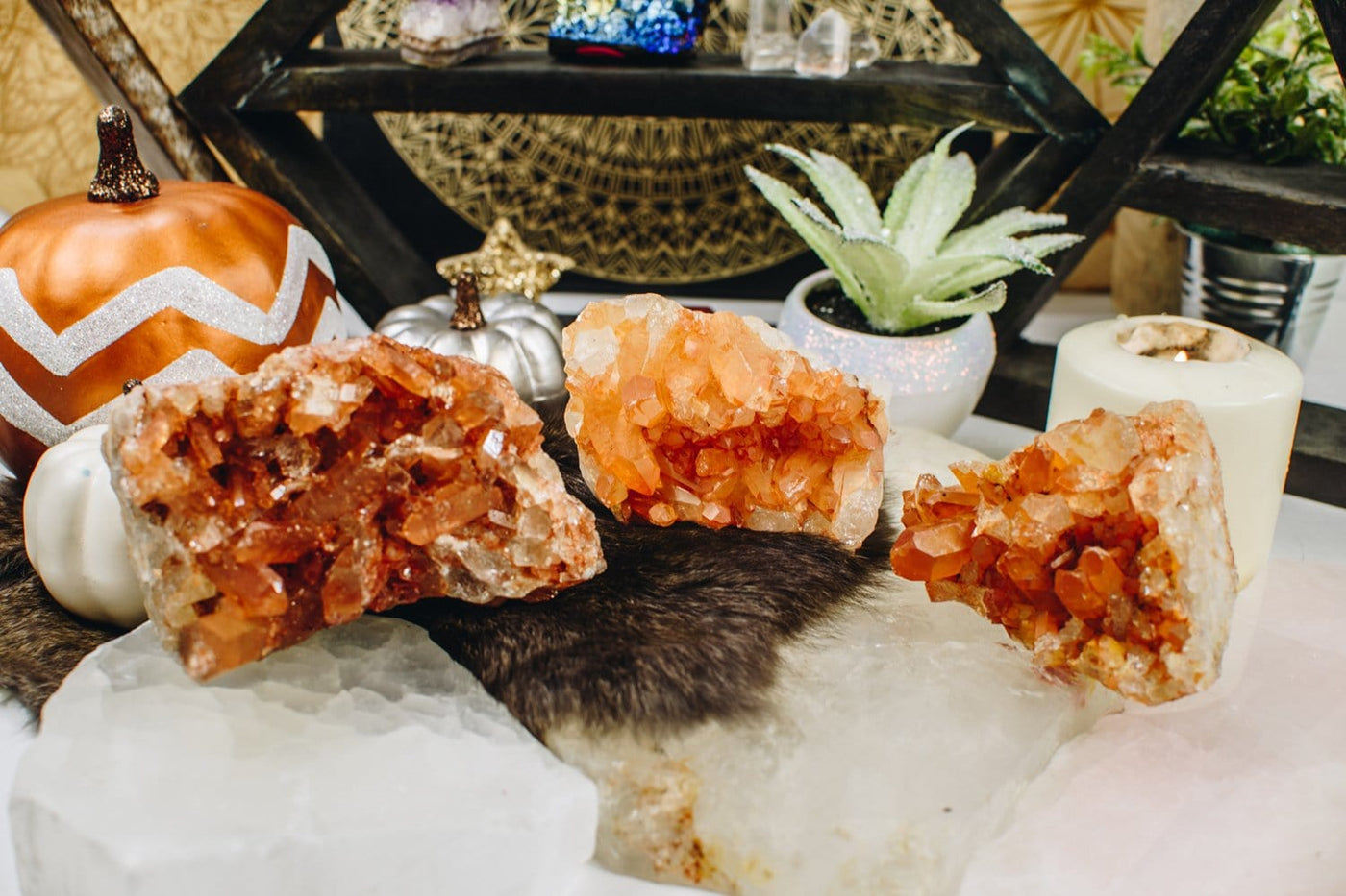 3 pieces of the Tangerine Quartz Clusters  on a table 