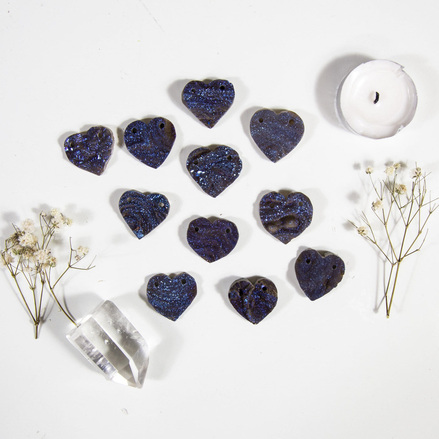 11 Chalcedony Heart Titanium Coated Blue double drilled beads on white background with decorations