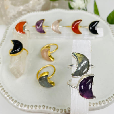 multiple moon gemstone rings displayed to show the differences in the gemstone options 