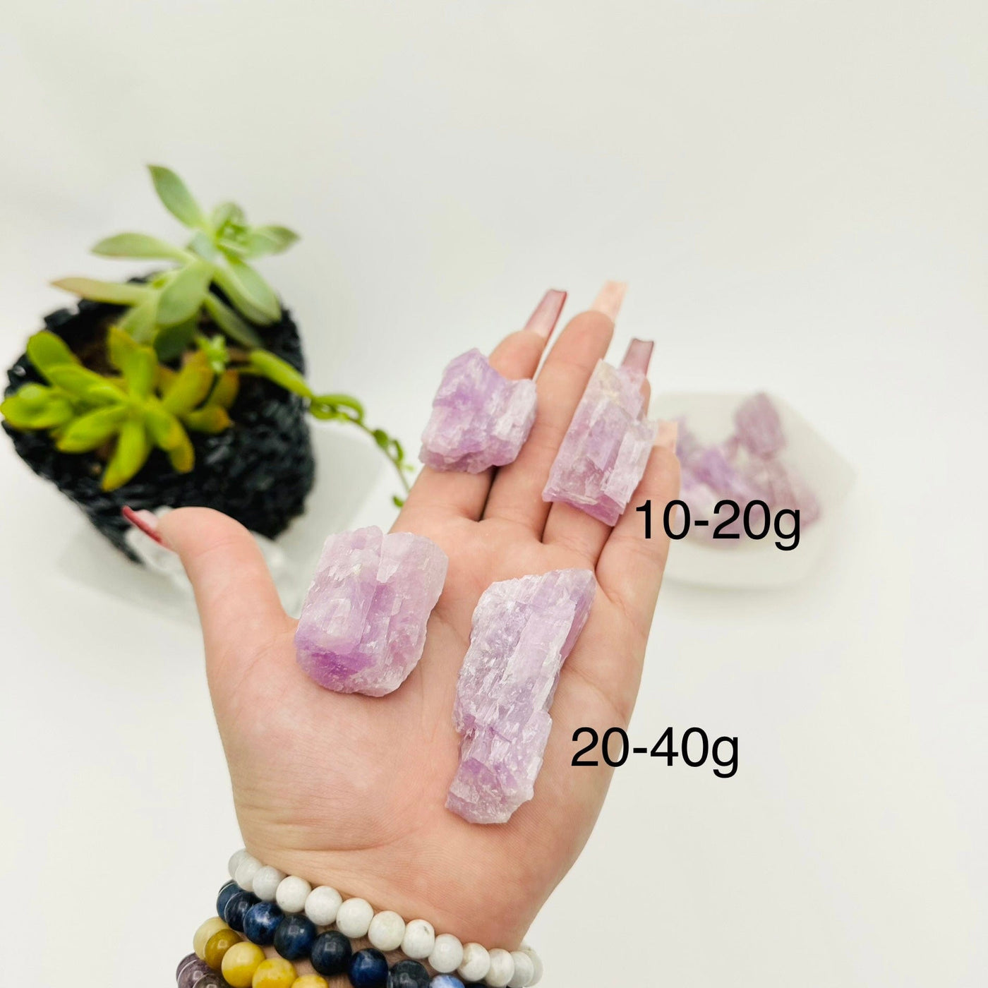 RAW KUNZITE - BY WEIGHT - four rocks in hand showing size for weights 10-20g and 20-40g