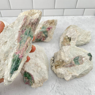 Raw Watermelon Tourmaline in hand for size reference 