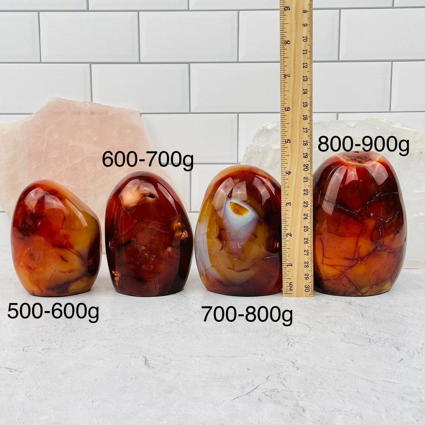 carnelian cut base sold by weight. cut base displayed next to a ruler for size reference