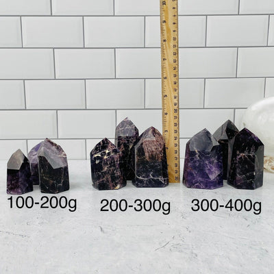 Purple Amethyst Point are sold by weight. points next to a ruler for size reference 