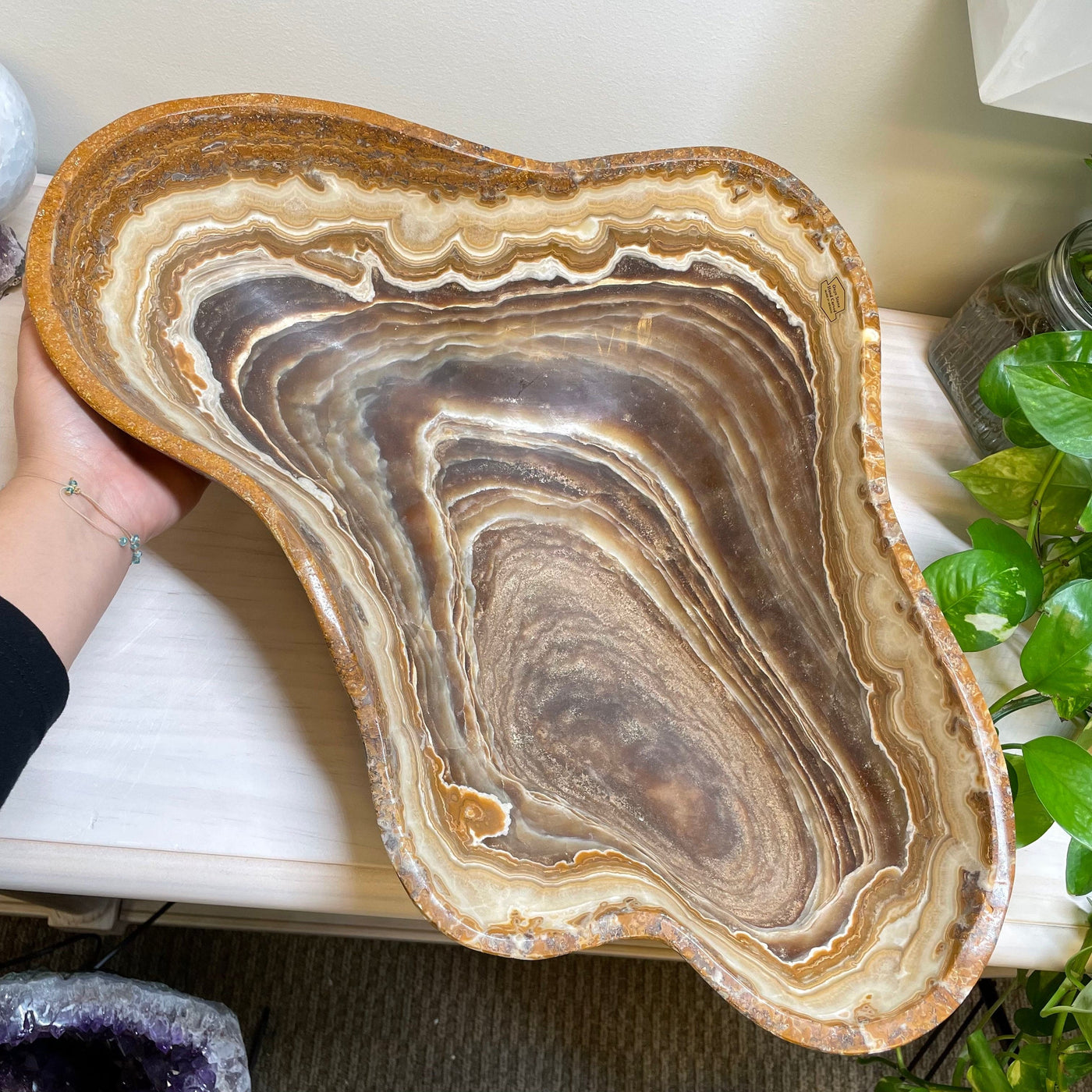 hand next to large mexican onyx bowl for size reference 