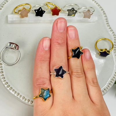 gemstone star ring displayed on hand for size reference 