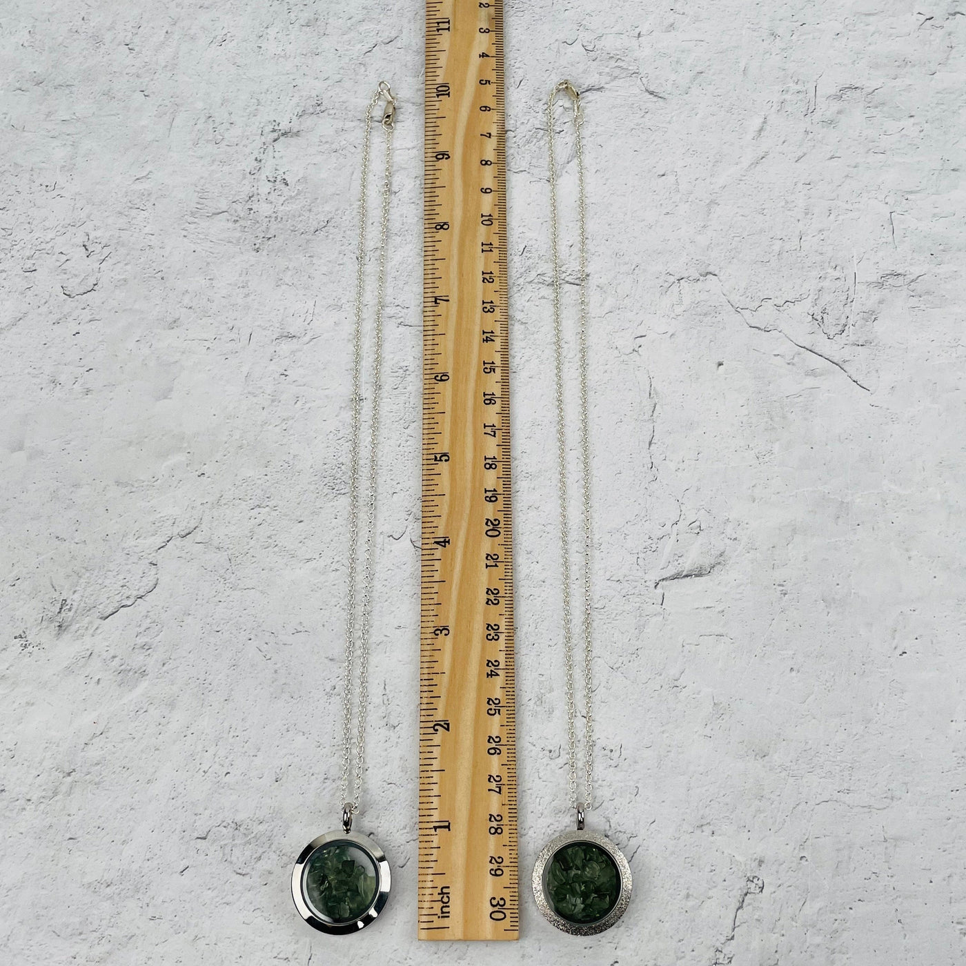 necklaces next to a ruler for size reference 