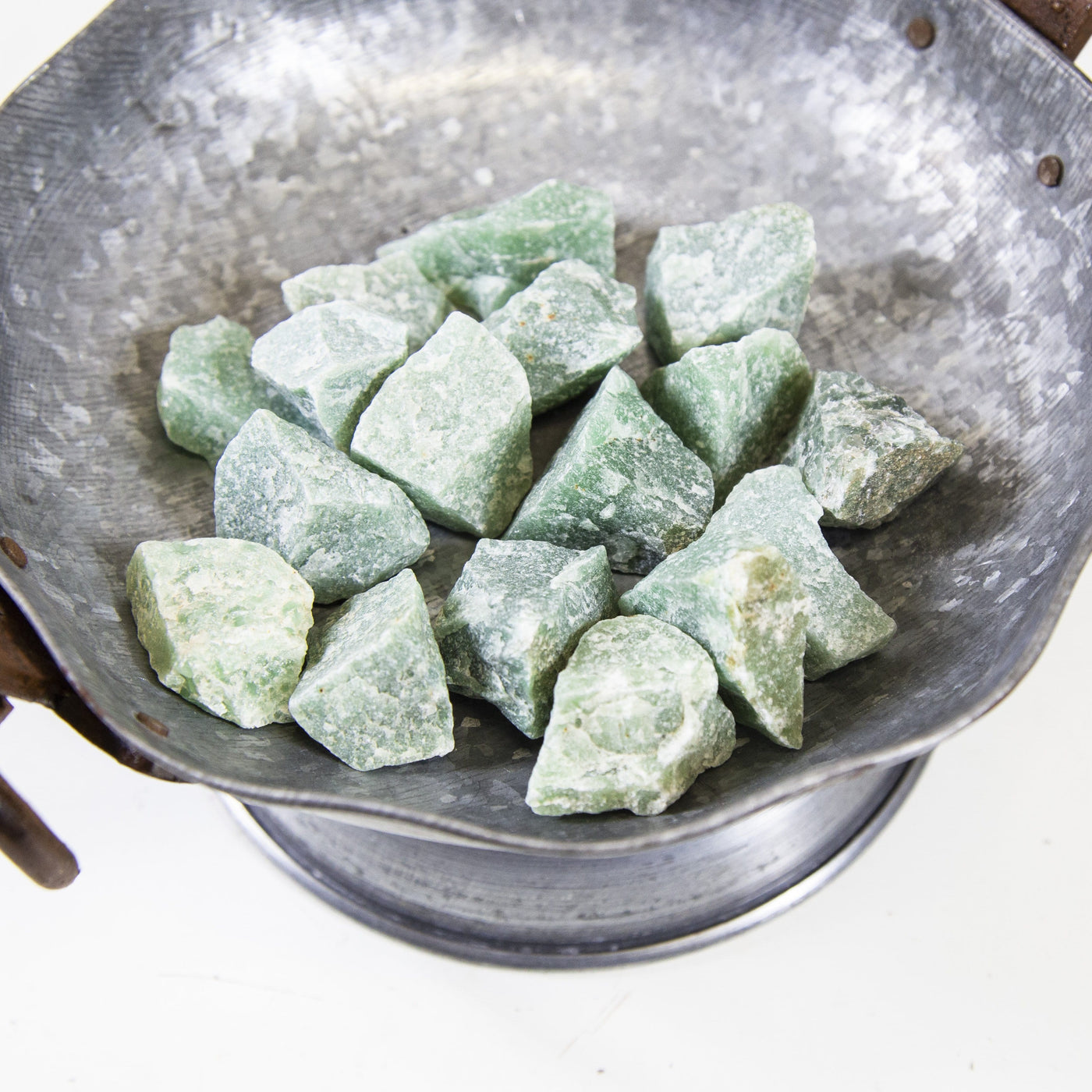 green quartz rough stones in a bowl
