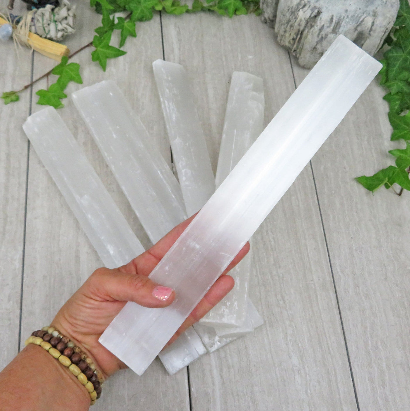 selenite bar in hand and on display