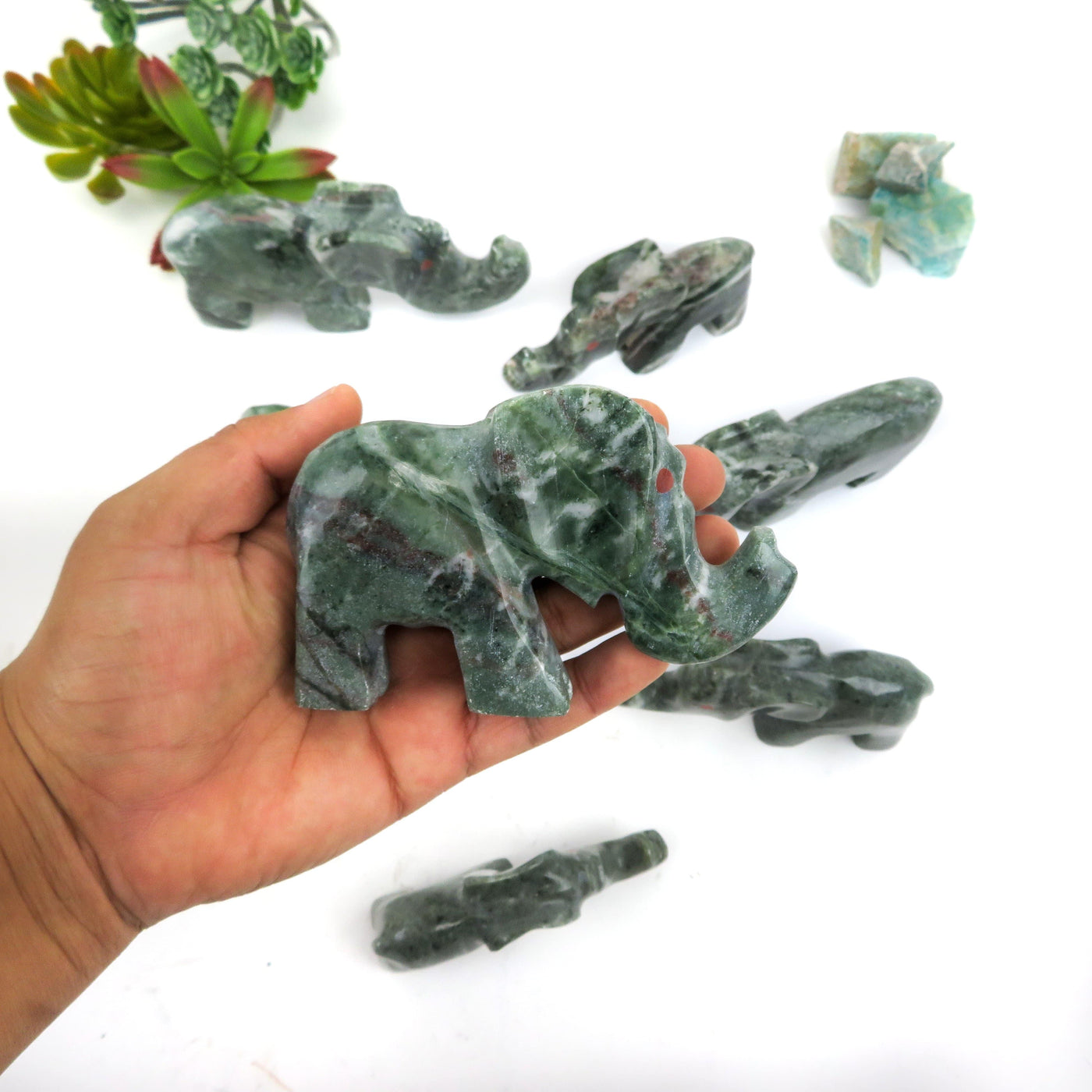 one tree agate elephant in a hand
