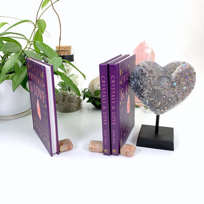 3 copies of Crystals & Love by Judy Hall displayed with decorations 
