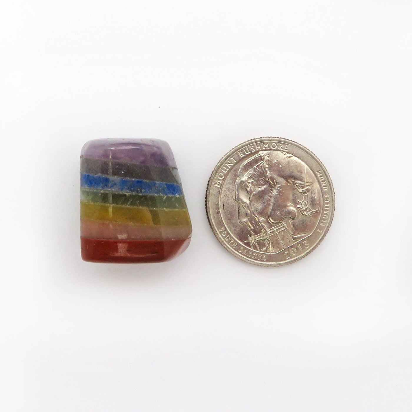 one seven chakra tumbled stone with quarter for size reference