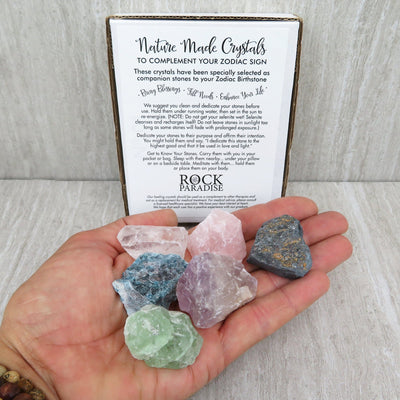 6 crystals from a zodiac box in a hand