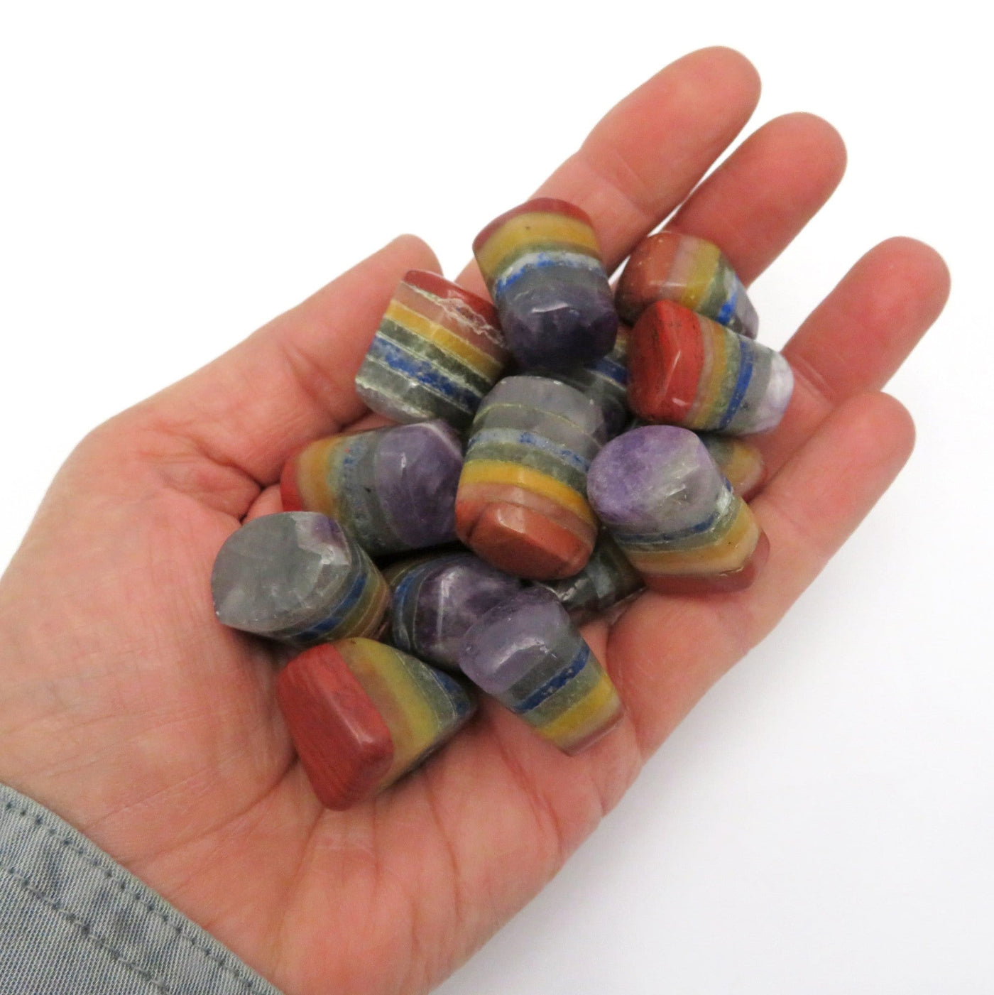Bonded 7 chakra Stones  in a pile in a hand