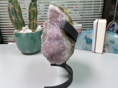 side view of amethyst formation with stalactites on metal stand