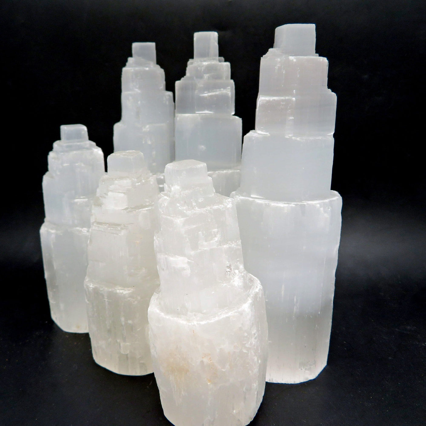 6 assorted selenite towers on a black background