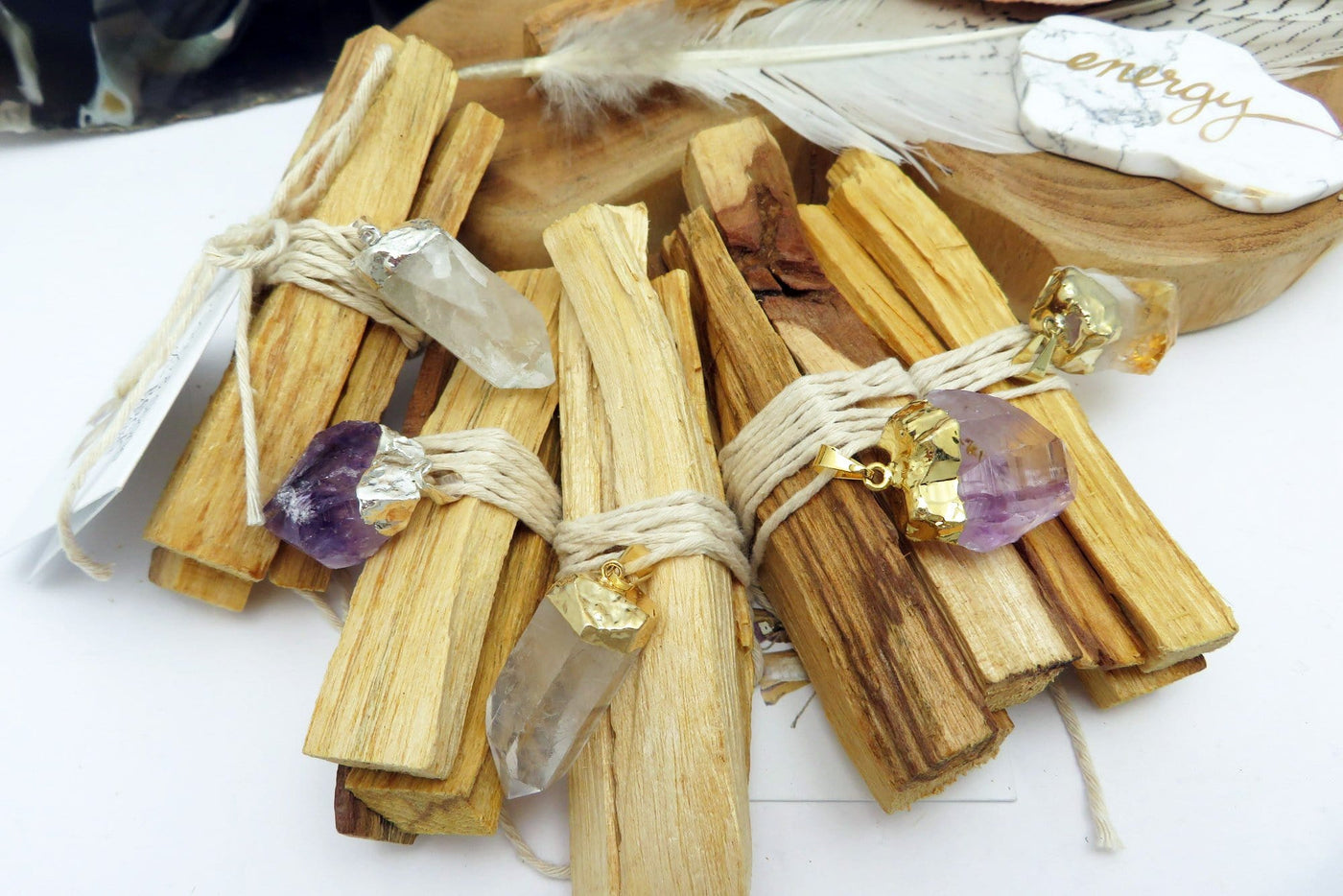 Close up view of five Palo Santo Bundle with variety of pendants 