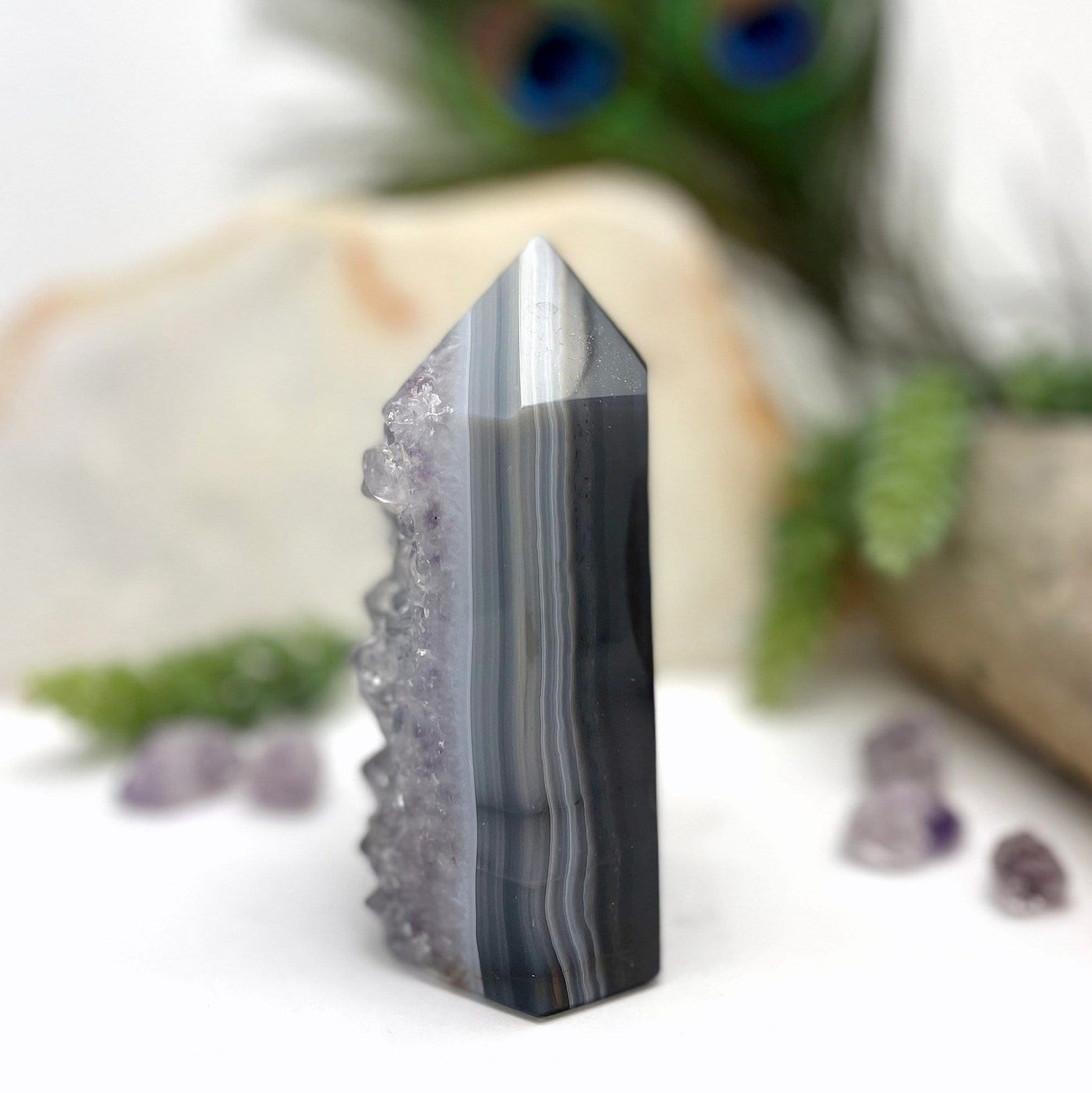 side view of Amethyst Polished Point with decorations in the background