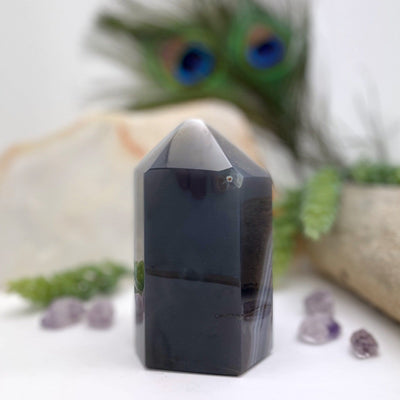 back view of Amethyst Polished Point with decorations in the background