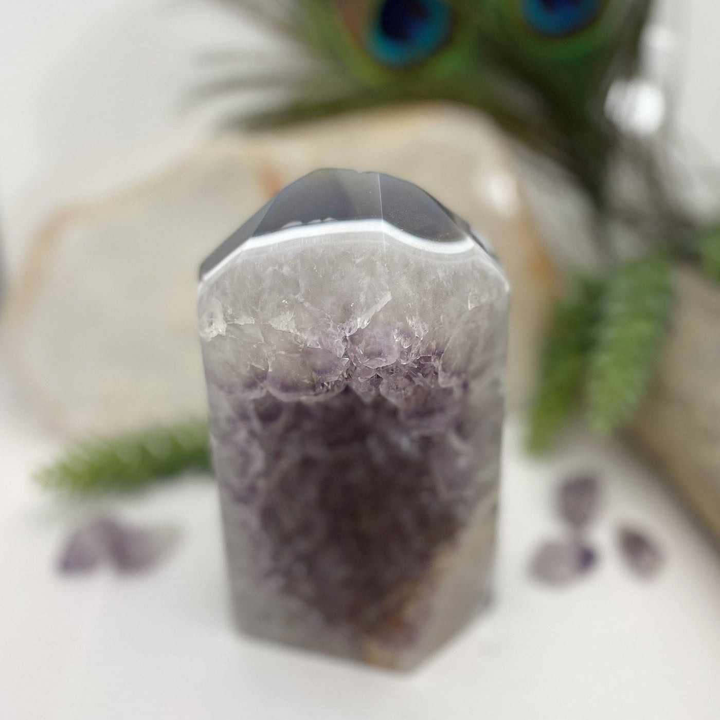 top view of Amethyst Polished Point with decorations in the background