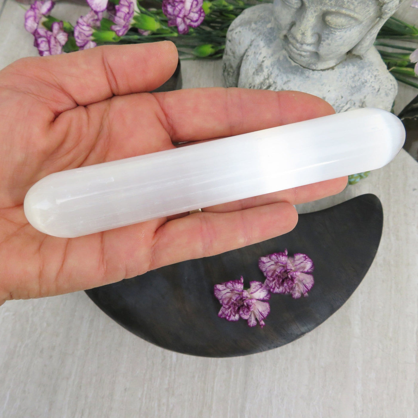 selenite wand in hand for size reference