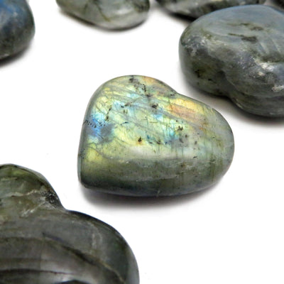 Side angle close up view of Labradorite Hearts on a white background
