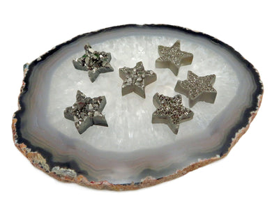 druzy stars with decorations in the background