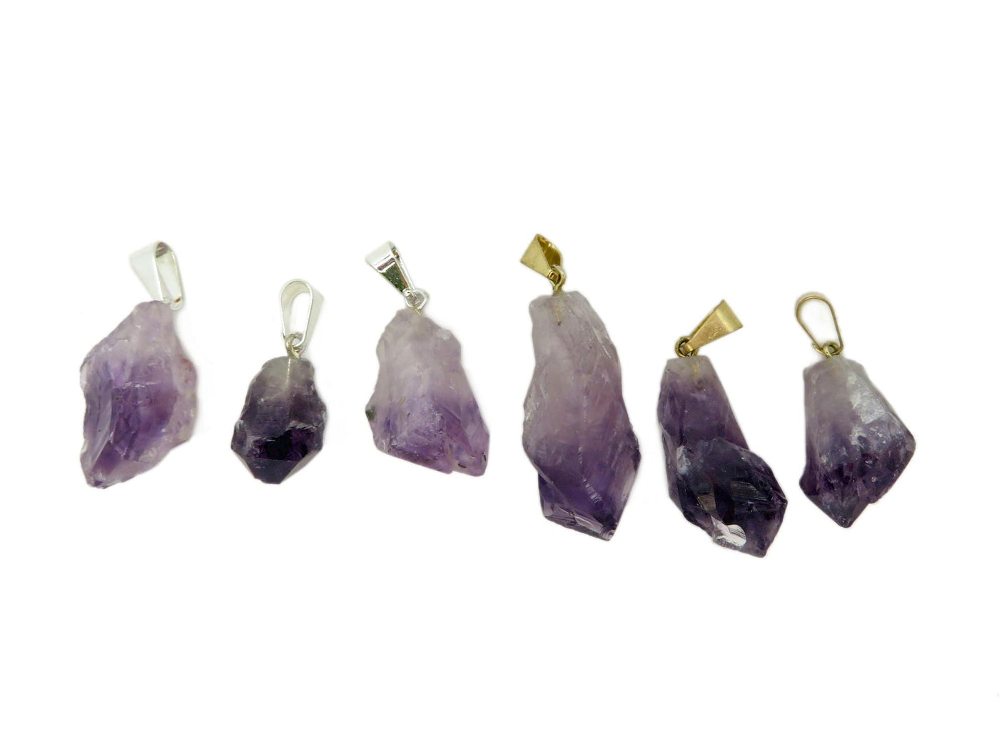 Three Petite Amethyst Quartz Point Pendant with silver bail on the left and three Petite Amethyst Quartz Point Pendant with gold bail on the right