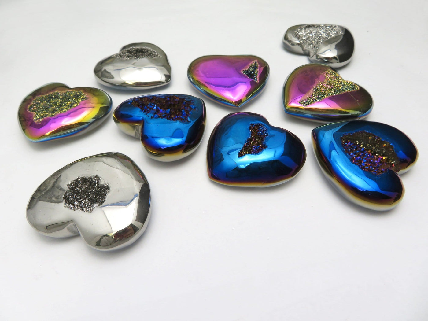 Titanium Druzy Hearts in mystic blue, platinum and rainbow laid out  on a table