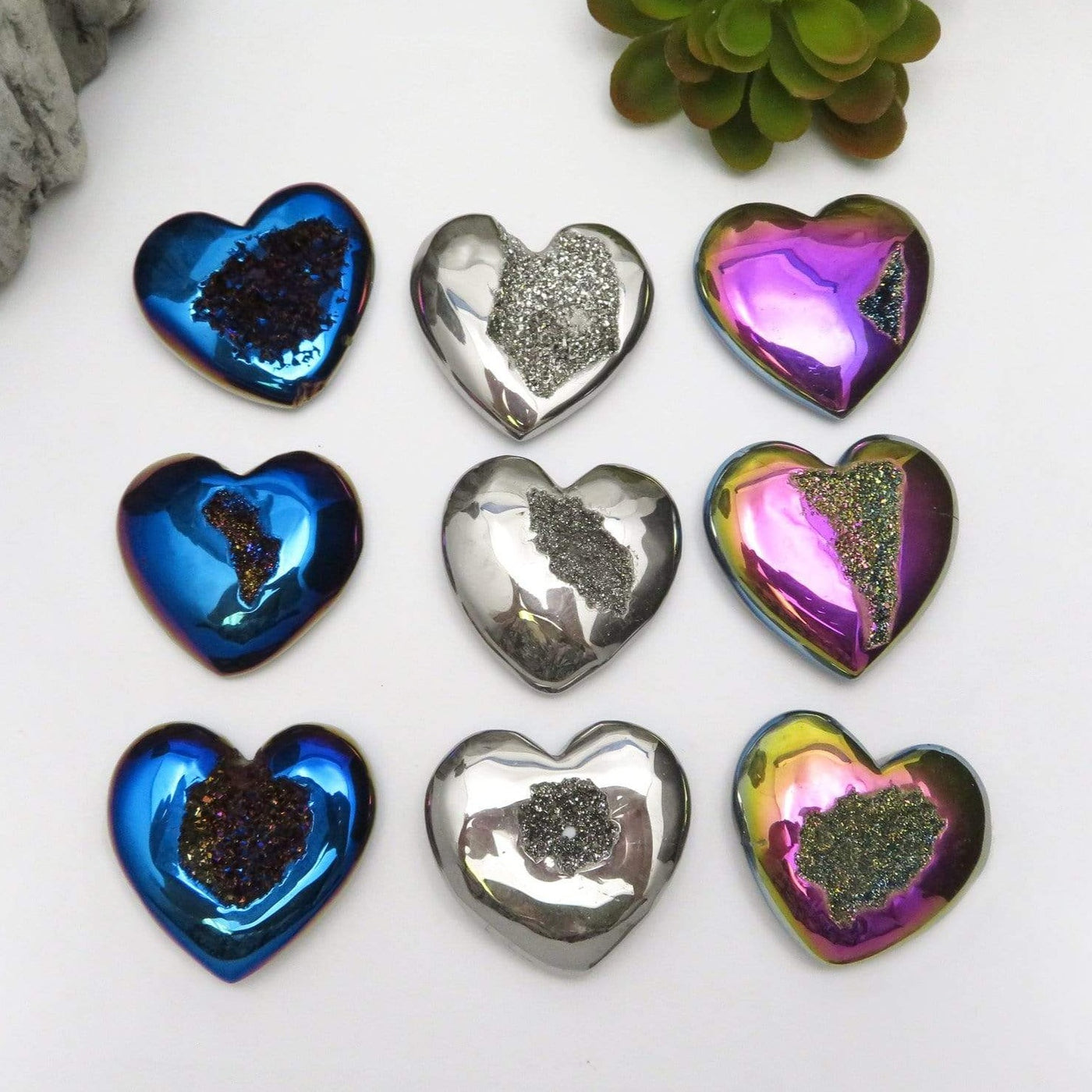 Titanium Druzy Hearts in mystic blue, platinum and rainbow laid out  on a table