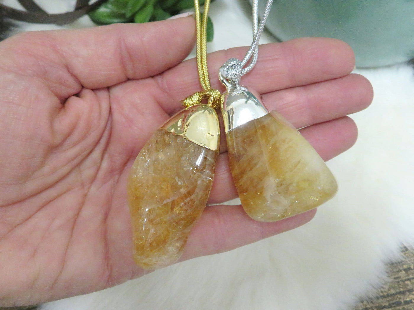 Citrine (heat treated) polished crystal ornament in hand for size reference