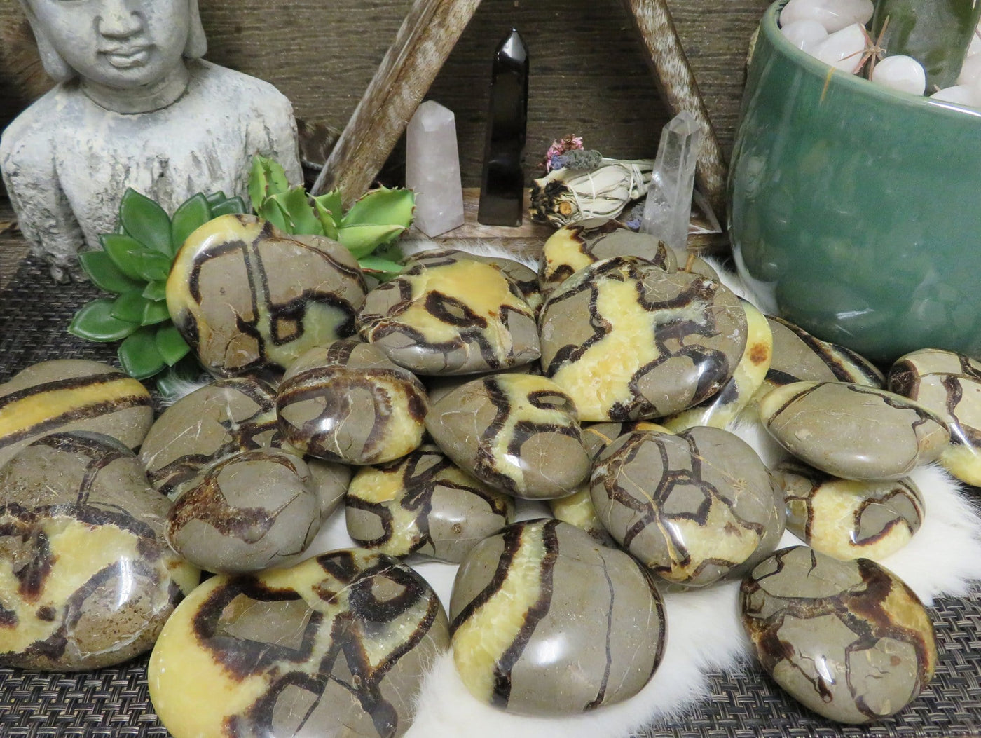 many septarian polished heart stones in a pile on display for possible variations