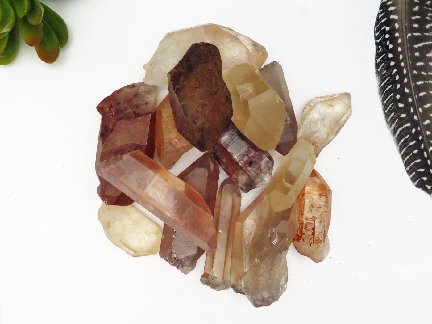 15 pieces of Tangerine quartz points piled on a table