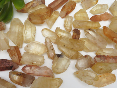 Pieces of Tangerine quartz points mixed on a table