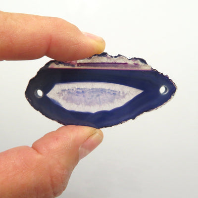 Picture of one of our purple agate slices being held for size reference. 