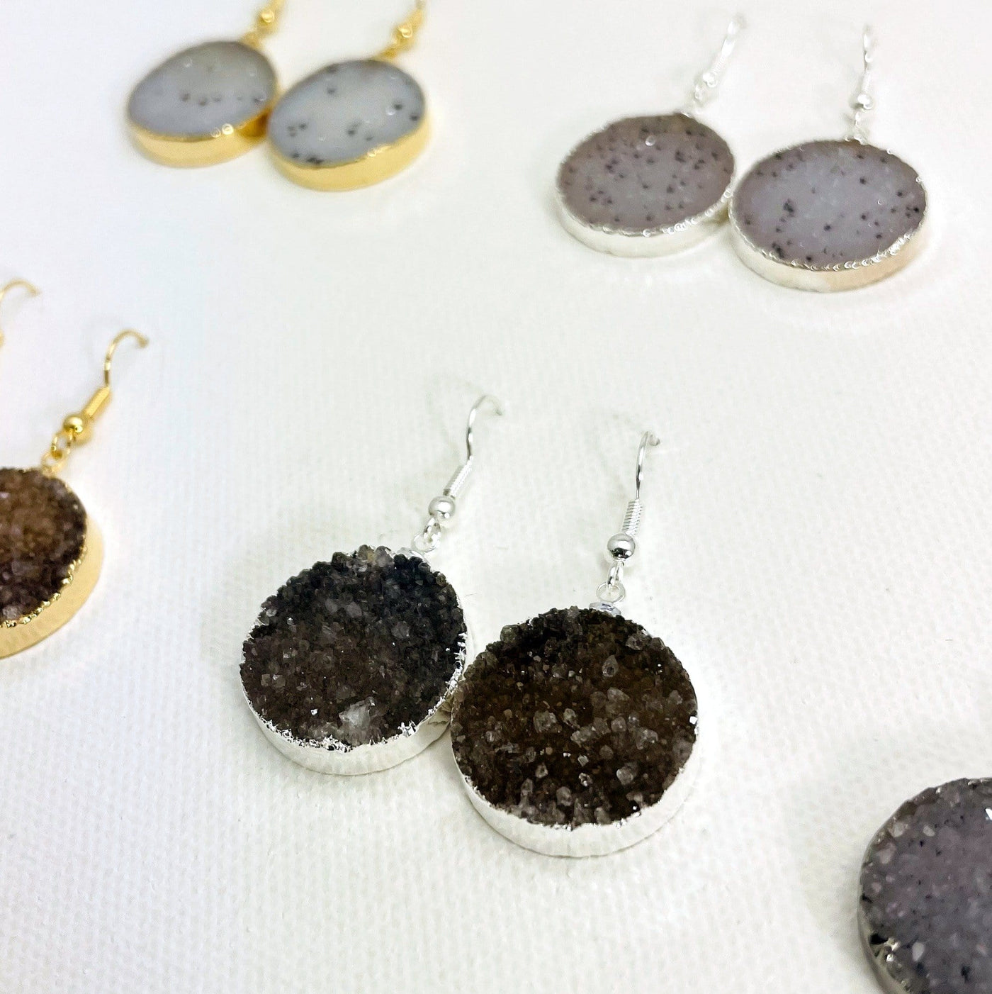 Close up of assorted druzy earrings.