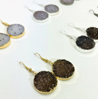 close up of assorted druzy earrings.