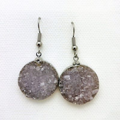 Close up of gray druzy earrings with silver plating.