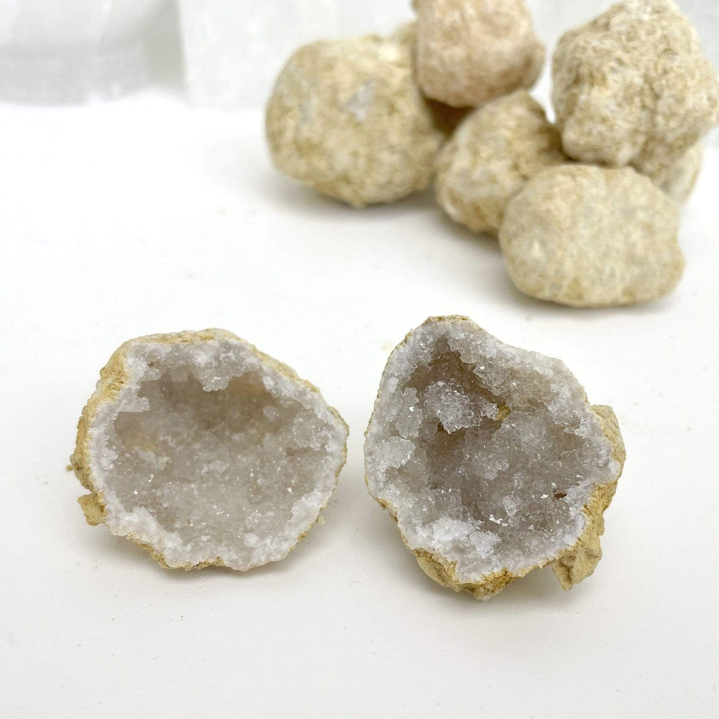 Single Break Your Own Geodes - White Color Geode opened up with bundle of geodes closed up in the back close up
