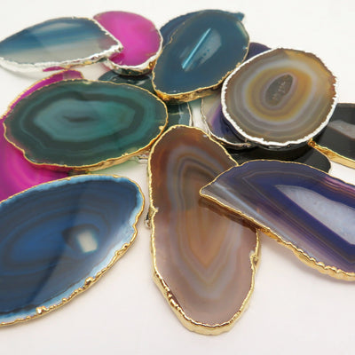 This picture is showing all the variety of colors we have available for our agate slices plated edge, on a white background.
