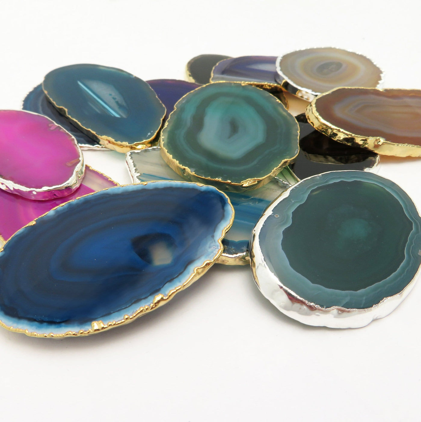 This picture is showing all the variety of colors we have available for our agate slices plated edge, on a white background.