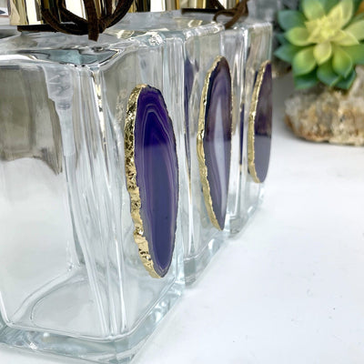 side picture  of three of our purple agate soap dispensers.