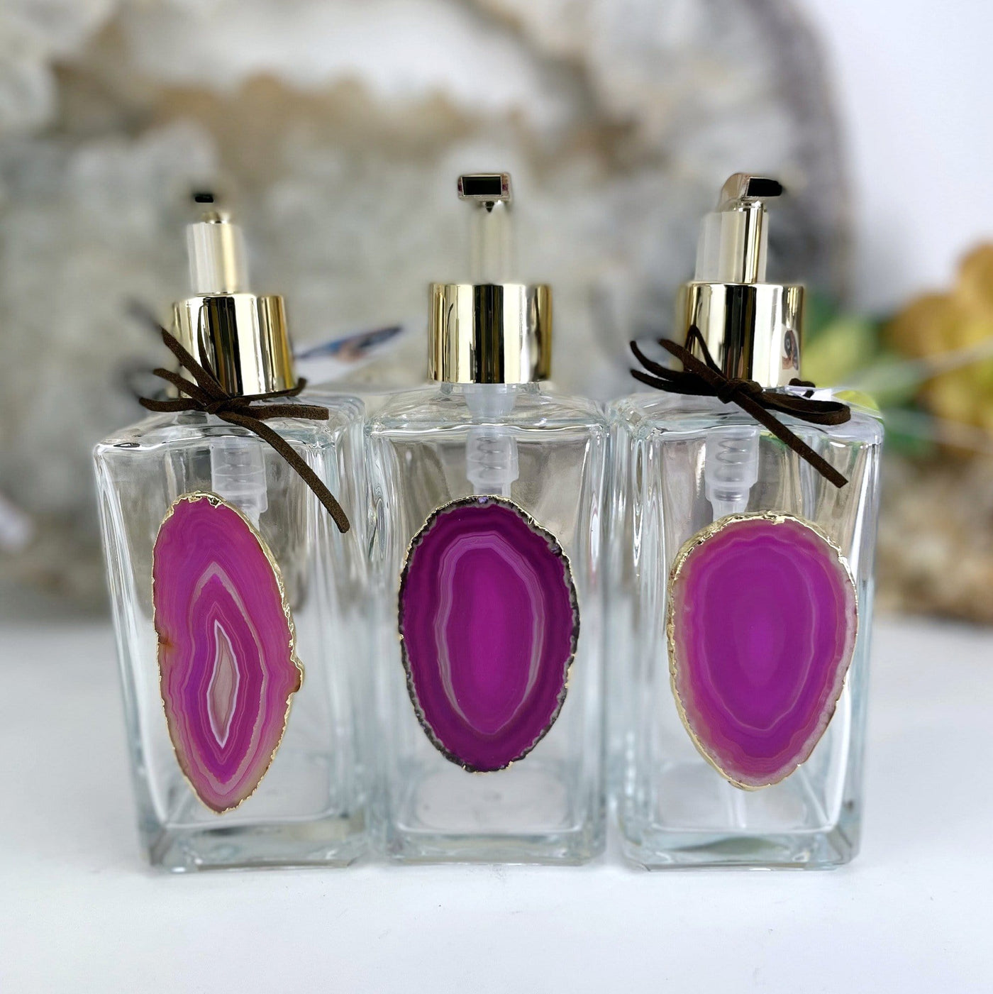 Picture of three of our pink agate soap dispensers.